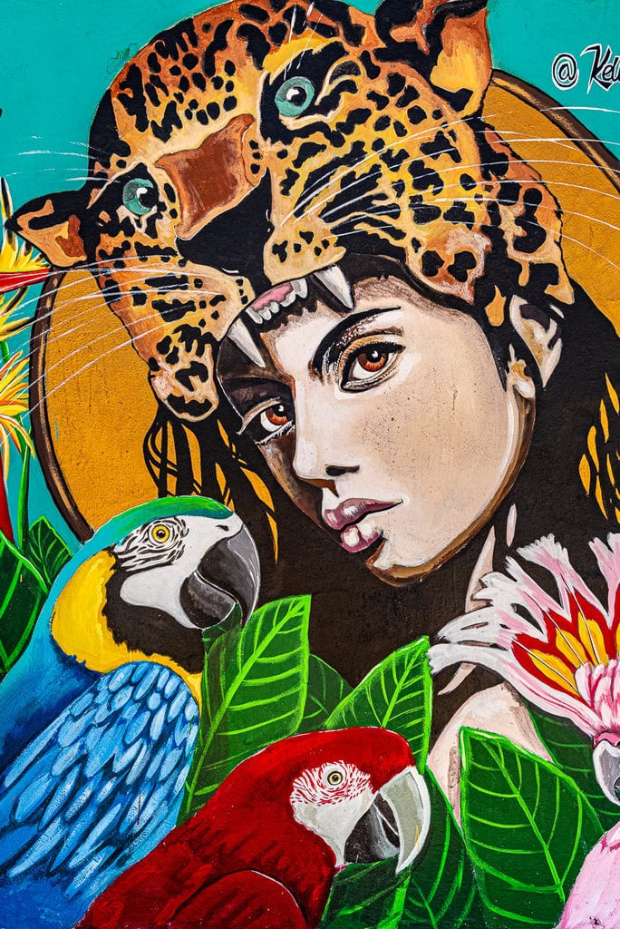 Street art depicting a close-up of a face with vibrant pink and blue accents.