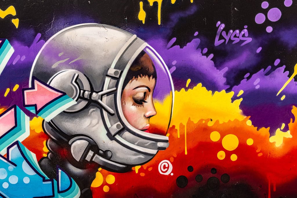 Graffiti of a woman surfer with dolphins and octopus, showcasing Bondi Beach.