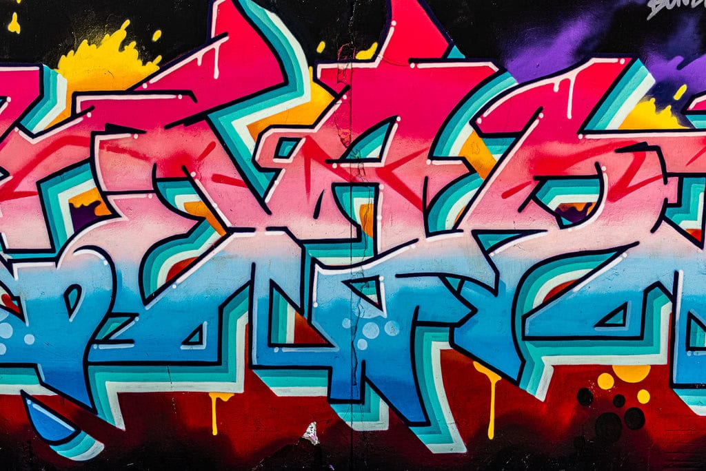 Street art of an astronaut helmet with a vibrant colorful background.