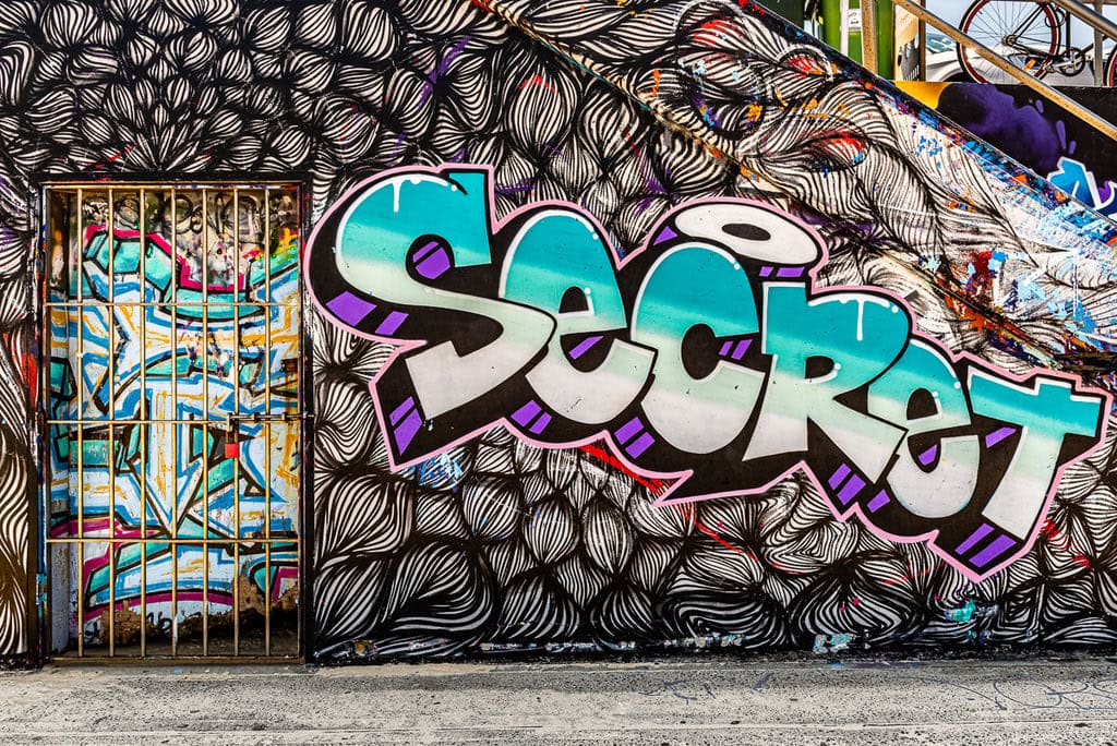 Colorful graffiti letters with a mix of pink, blue, and yellow.