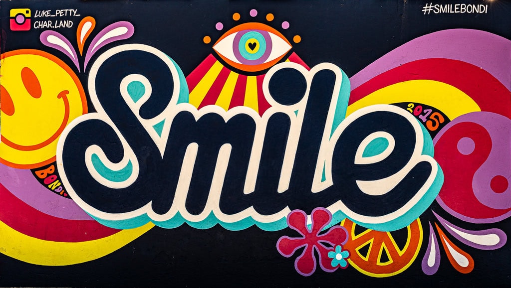 Mural with the word “Smile” in bold letters, surrounded by colorful shapes and patterns.