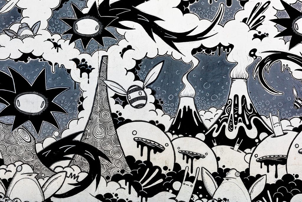 Black and white doodle-style graffiti with abstract characters and landscapes.