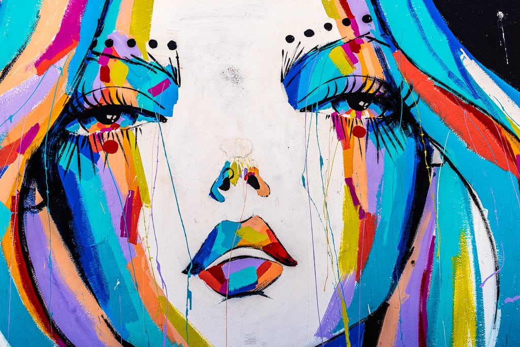 Colorful mural of a woman’s face with vibrant rainbow colors.