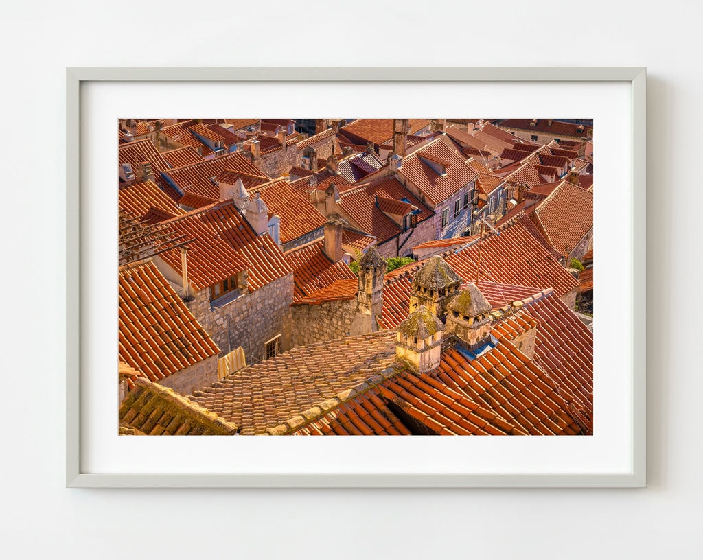 Stunning sunset illuminating the Croatia roof tiles of Dubrovnik, creating a warm, picturesque cityscape.