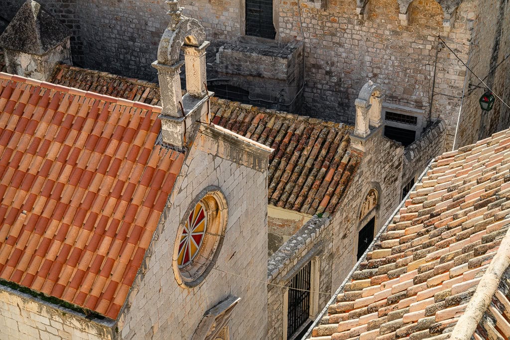 Stunning rooftop view overlooking a church in Dubrovnik, highlighted by the picturesque Croatia roof tiles.