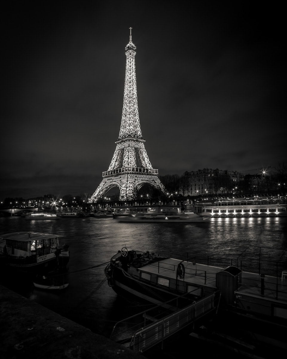 The Eiffel Tower glows over the Seine in quiet elegance.