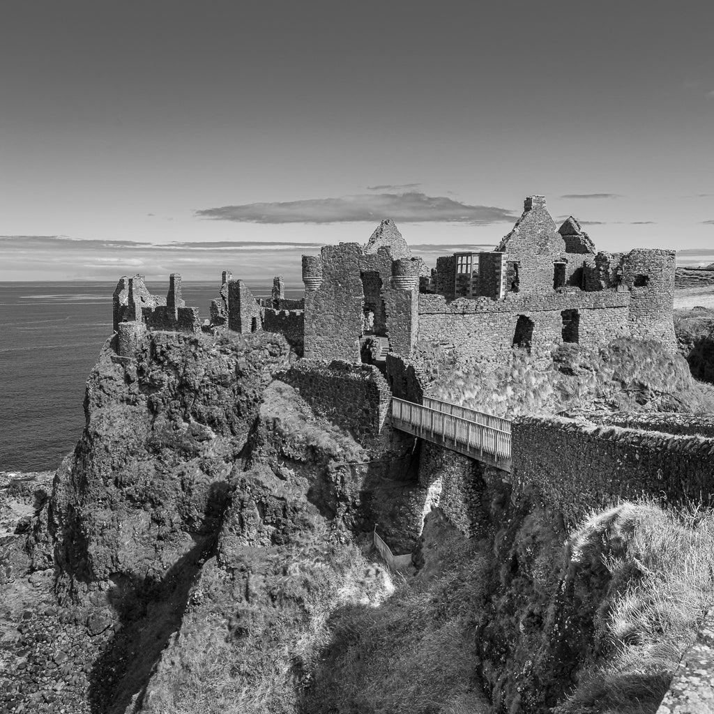 Medieval Echoes: Dunluce Castle stands as a dramatic testament to Northern Ireland's storied past, perched precariously at the edge of the Antrim coast.