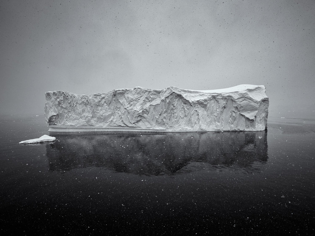Majestic Iceberg Amid Antarctic Snowstorm Dramatic Photo | Black and White Wall Art