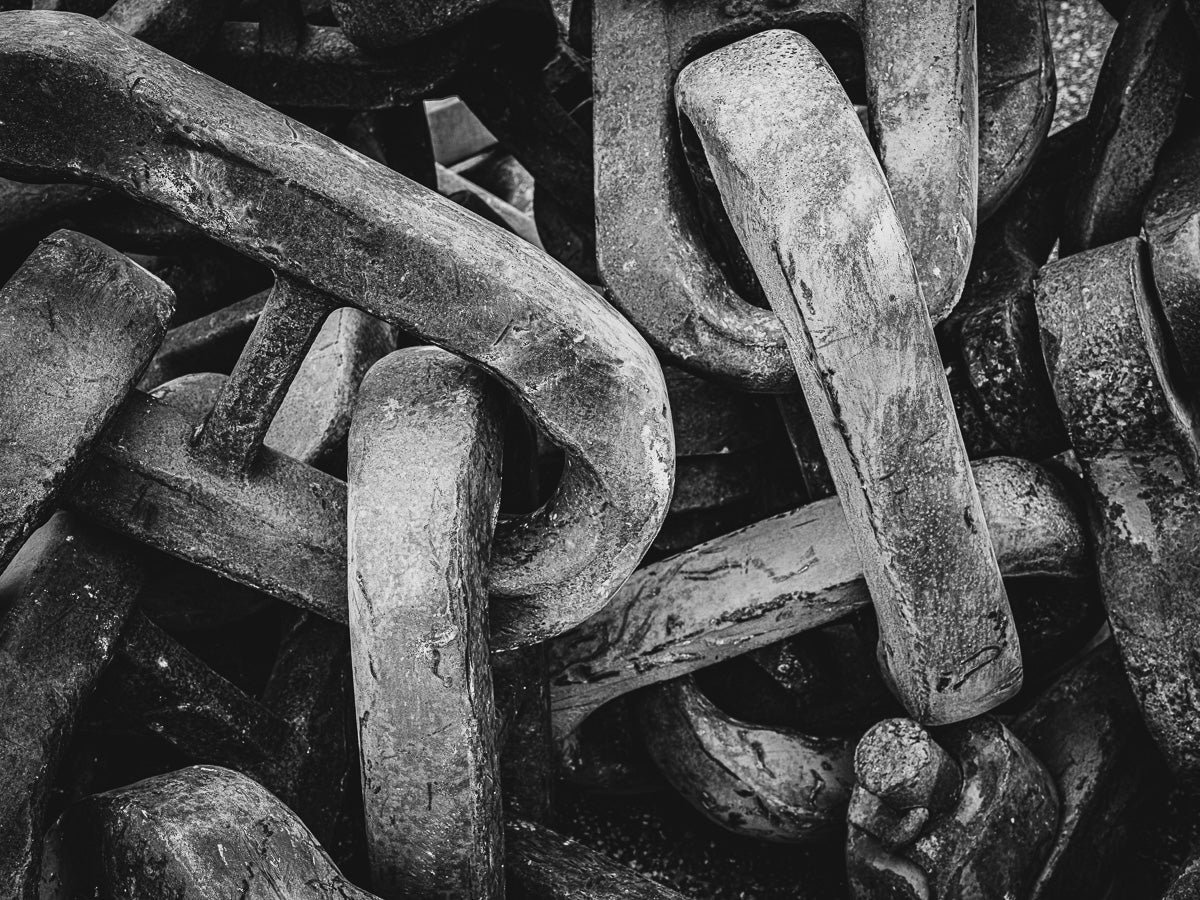 Weight and repetition—these heavy chains speak to an era of brute force and unrelenting purpose, now stilled in time.
