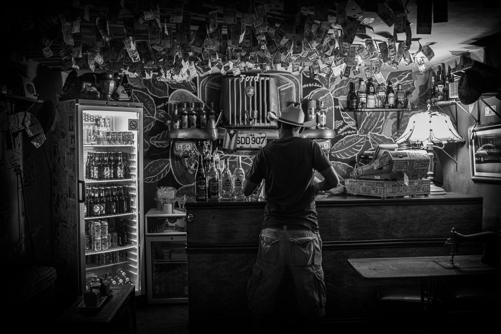 In the dim light of a Cuban bar, this scene captures the essence of street photography—an intimate, unguarded moment that tells a story without words. As we wrap up, remember that street photography is about being present, observing life, and capturing those fleeting moments that speak volumes.