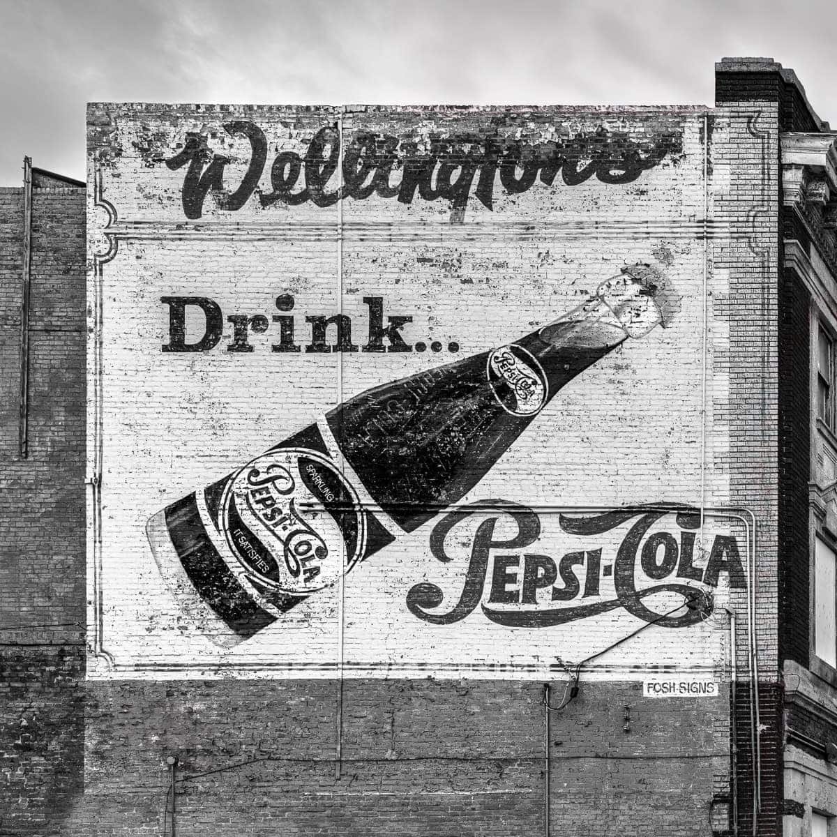 A weathered Pepsi-Cola ad lingers on a brick wall in Winnipeg.