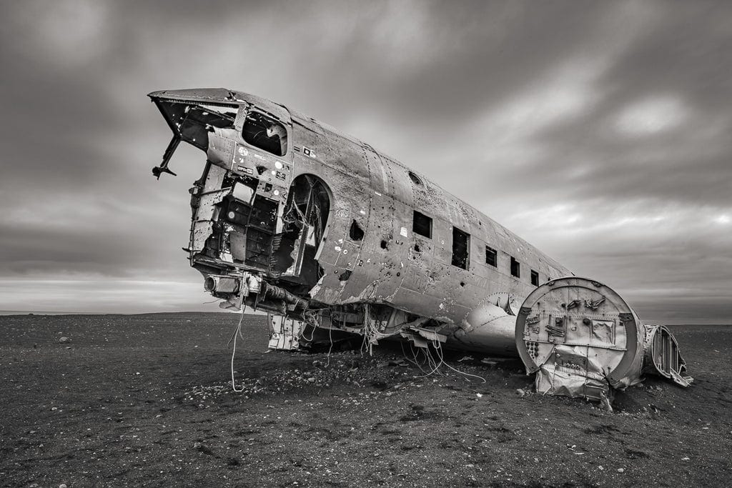 Abandoned Photography Artist captures a hauntingly isolated old plane crash on Iceland's Sólheimasandur Beach, embodying desolation and forgotten history.