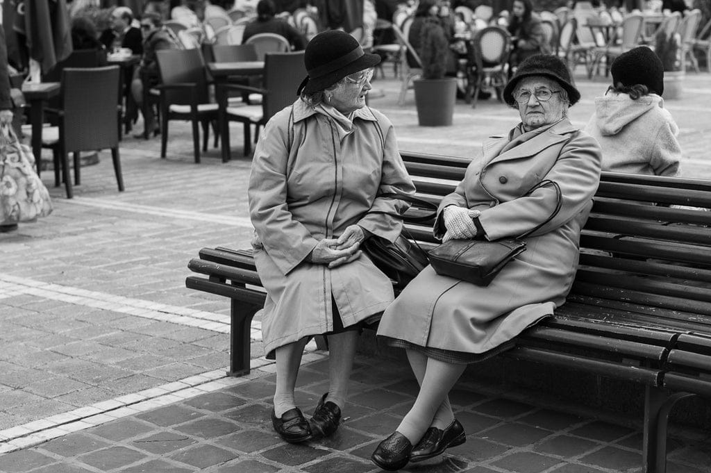 Using the video camera technique, I was able to discreetly capture this candid moment of two women in conversation, allowing the scene to unfold naturally without drawing attention to myself.