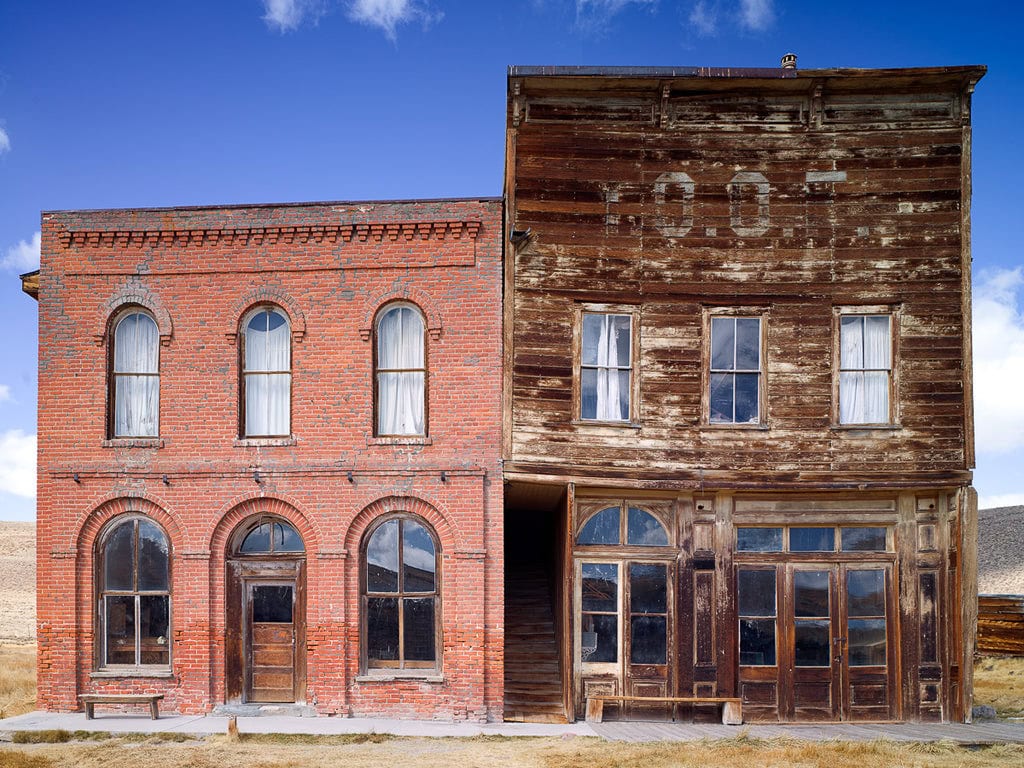 Eerie capture by an Abandoned Photography Artist of an Old West saloon, standing desolate, echoing the untold stories of a bygone era.