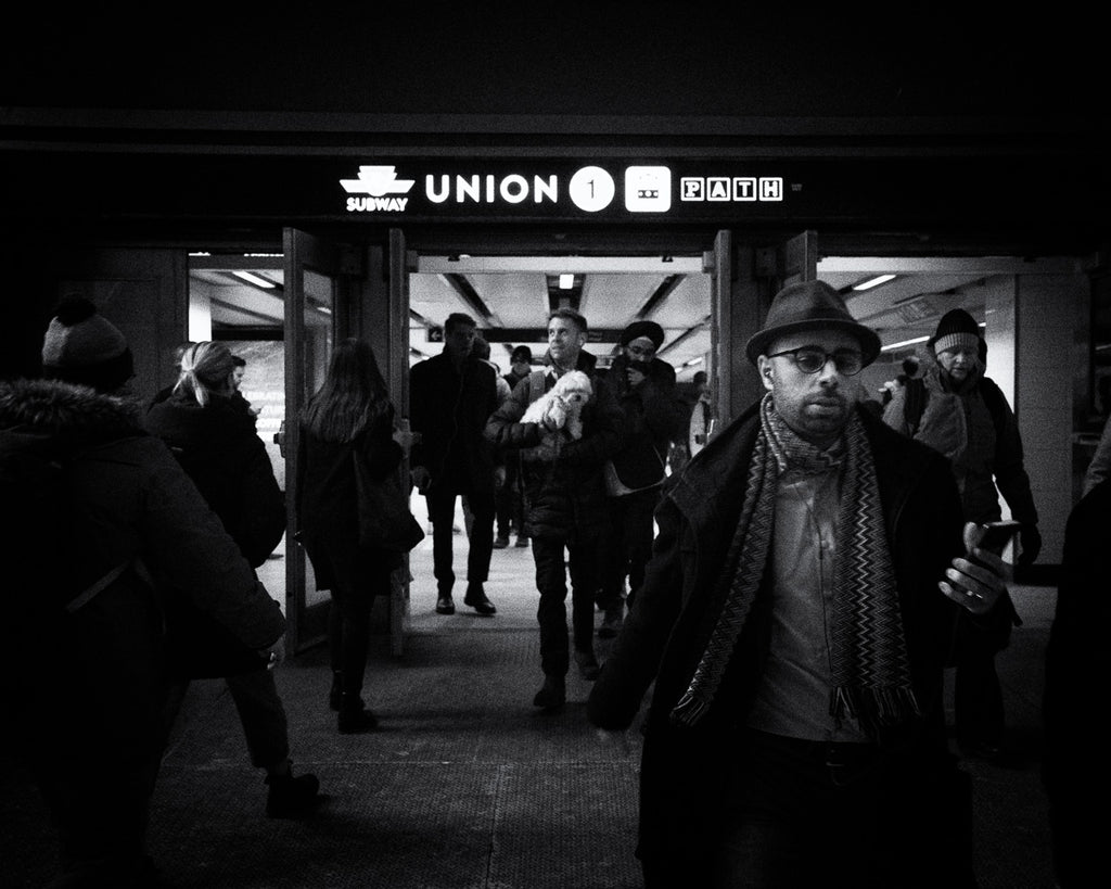 Young man with a dog leaving the train station in Toronto's Downtown Core