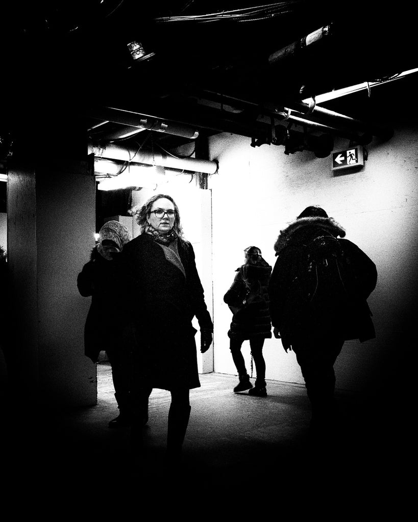 Dark passage in Toronto’s Union Station as people journey oblivious of other passengers