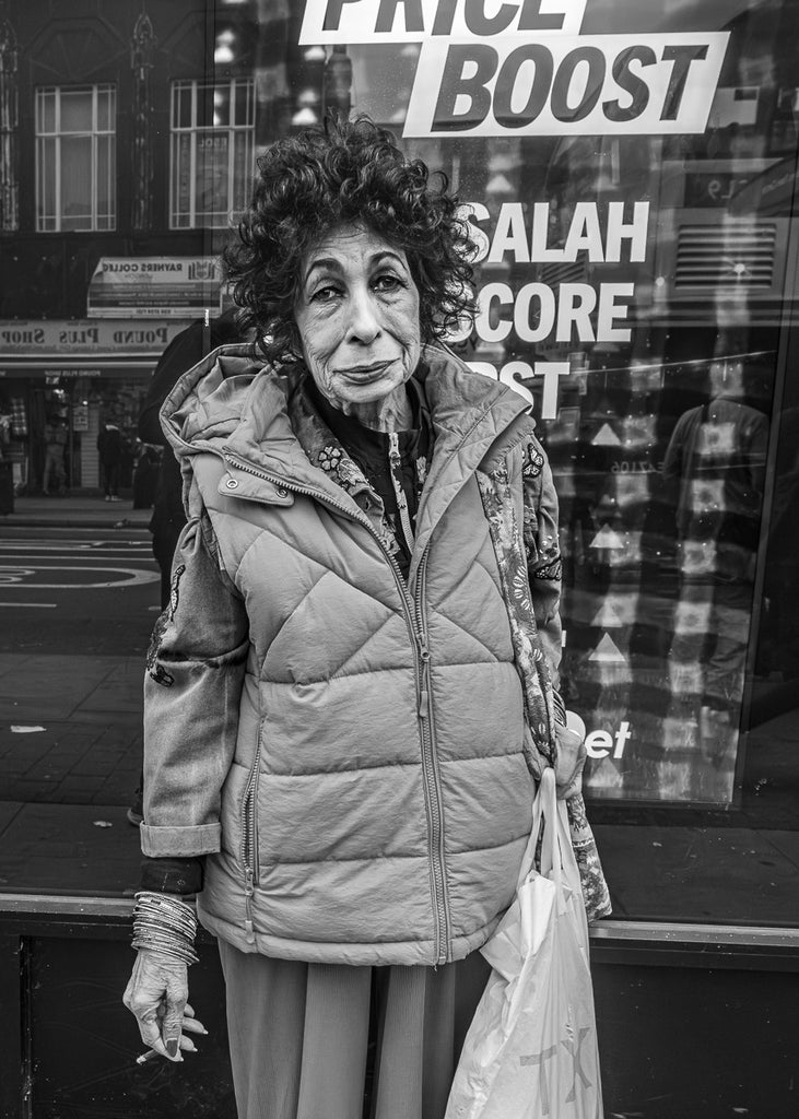 This portrait captures a moment of connection—a brief exchange that turned into a powerful image. Sometimes, stepping out from behind the camera and engaging with your subject leads to the most compelling stories.