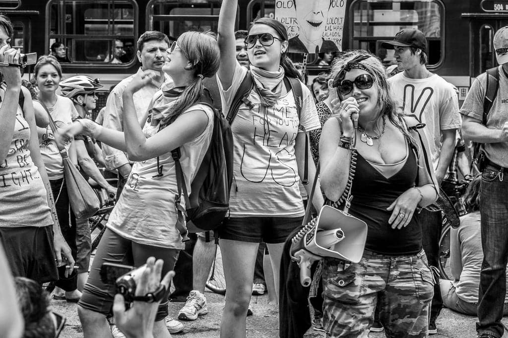 Captured in manual mode with a Leica M9 Rangefinder and 75mm lens at 1/90 sec, f/9.5, ISO 160—settings chosen to capture the sharp, active scene with minimal noise during a protest at the G20 Summit in Toronto.