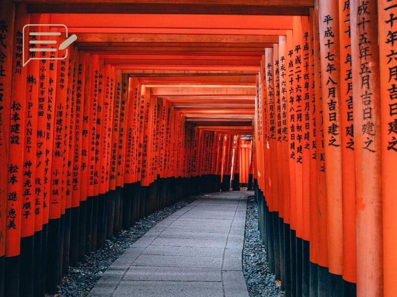 The famous torii gates of Fushimi Inari Shrine, framed by autumn colors, a must-see in Japan.