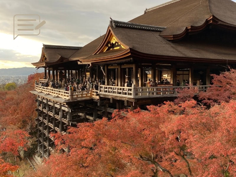 Visitors enjoy the breathtaking views of autumn leaves from Kiyomizu-dera in Kyoto, Japan.